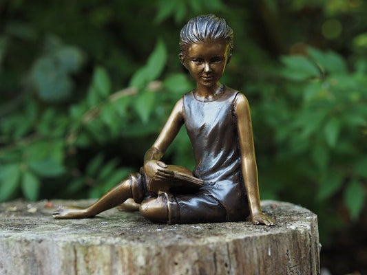 Bronzen beeld meisje op stoel